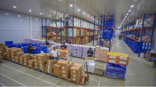 Active warehouse floor with staff and inventory handling